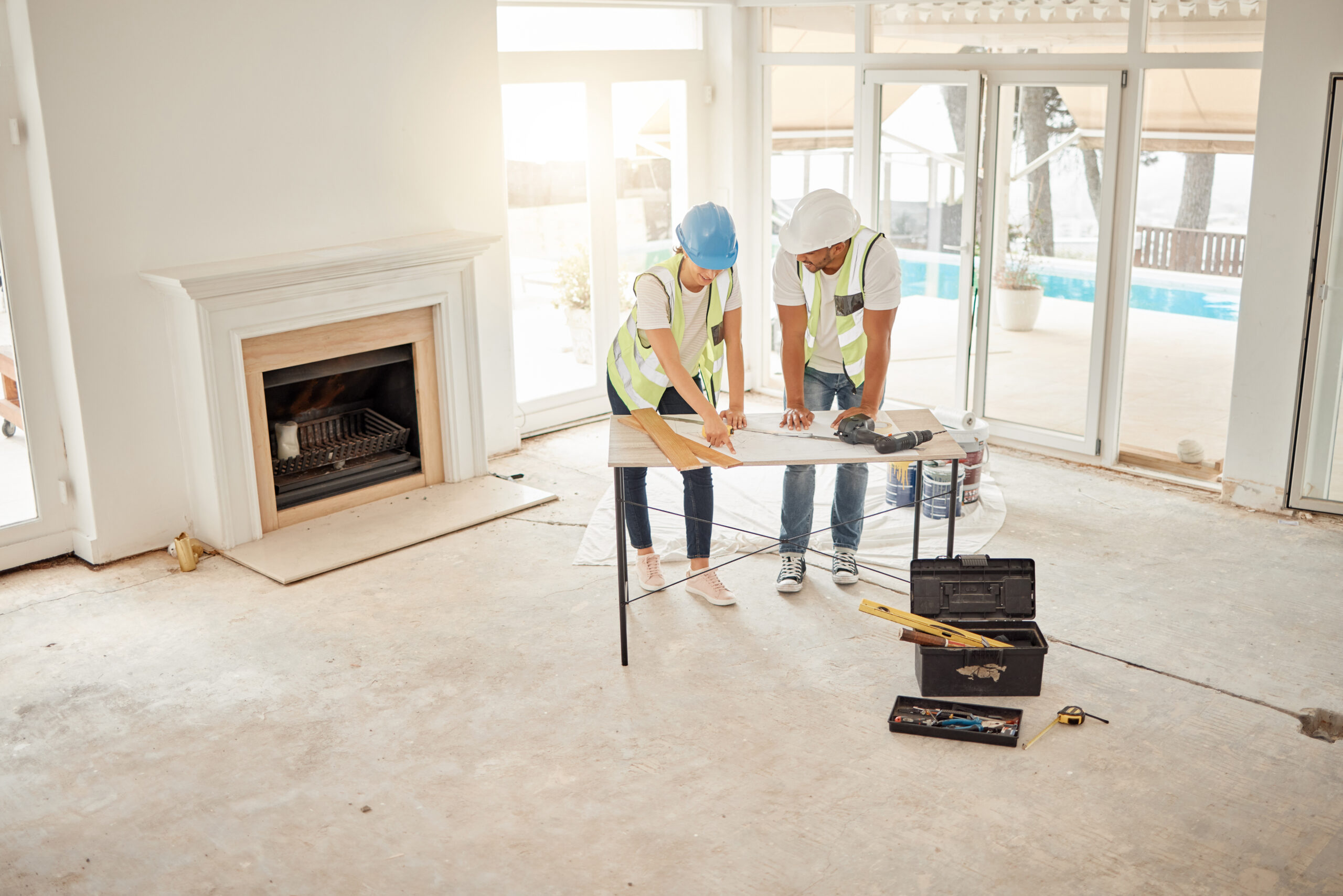 Contractors reviewing renovation plans inside a bright Hudson Valley home during an interior remodeling project